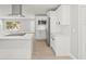 Modern kitchen with white cabinets, stainless steel appliances and a kitchen island at 2433 Blind Pond Ave, Lutz, FL 33549