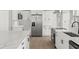 Modern kitchen features quartz countertops, stainless steel appliances, and an open layout with wood-look flooring at 2433 Blind Pond Ave, Lutz, FL 33549