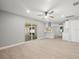 Living room featuring sliding glass door and a view to the kitchen at 2433 Blind Pond Ave, Lutz, FL 33549