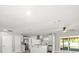 Open-concept living space with a modern kitchen, stainless appliances, and sliding glass doors to the patio at 2433 Blind Pond Ave, Lutz, FL 33549
