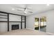 Cozy living room with a modern fireplace, built-in shelving, and sliding glass doors at 2433 Blind Pond Ave, Lutz, FL 33549