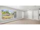 Spacious living room with large window and modern flooring at 2433 Blind Pond Ave, Lutz, FL 33549