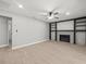 Open living room featuring a fireplace, built-in shelves, and modern flooring at 2433 Blind Pond Ave, Lutz, FL 33549