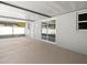Covered patio with sliding glass doors leads to backyard at 2433 Blind Pond Ave, Lutz, FL 33549