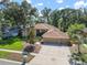 Aerial view of a home showcasing a three-car garage and mature landscaping at 2903 Manor Ridge Pl, Valrico, FL 33596