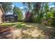 Large backyard with a screen-enclosed patio with seating and a mulched landscape bed at 2903 Manor Ridge Pl, Valrico, FL 33596