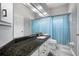 Bathroom featuring a granite countertop, white cabinets, a blue shower curtain, and an oversized mirror at 2903 Manor Ridge Pl, Valrico, FL 33596