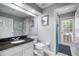 Bathroom with a granite countertop, a single sink, and a door leading to the pool area at 2903 Manor Ridge Pl, Valrico, FL 33596
