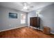 Cozy bedroom featuring a wooden armoire, window, and hardwood floors at 2903 Manor Ridge Pl, Valrico, FL 33596