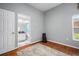 Bright bedroom with wood floors, a colorful rug, and an attached bathroom with a single sink at 2903 Manor Ridge Pl, Valrico, FL 33596