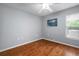 Simple bedroom featuring a window, hardwood floors, and ample space at 2903 Manor Ridge Pl, Valrico, FL 33596