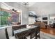 Bright dining area with wood floors and views of the screened-in lanai and pool at 2903 Manor Ridge Pl, Valrico, FL 33596