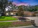 Beautiful single-story home featuring a well-manicured lawn, mature landscaping, and a charming facade at 2903 Manor Ridge Pl, Valrico, FL 33596