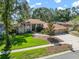 Aerial view of the home with well-manicured lawn and mature landscaping at 2903 Manor Ridge Pl, Valrico, FL 33596