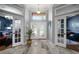 Grand foyer with decorative glass double doors and views into the adjacent rooms at 2903 Manor Ridge Pl, Valrico, FL 33596