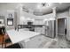 Modern kitchen features stone countertops, stainless appliances, and grey backsplash at 2903 Manor Ridge Pl, Valrico, FL 33596