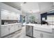 Kitchen with modern white cabinetry, stainless steel appliances, and backyard access at 2903 Manor Ridge Pl, Valrico, FL 33596