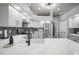Modern white kitchen with stainless steel appliances and stone countertops at 2903 Manor Ridge Pl, Valrico, FL 33596