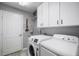 Laundry room with a washer, dryer, utility sink, and overhead cabinets at 2903 Manor Ridge Pl, Valrico, FL 33596