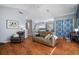 Cozy living room with hardwood floors, neutral colors, and comfortable seating at 2903 Manor Ridge Pl, Valrico, FL 33596