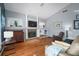 Living room features a fireplace, hardwood floors, and neutral-toned decor at 2903 Manor Ridge Pl, Valrico, FL 33596