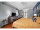Comfortable main bedroom featuring stylish decor, tv, and hardwood floors throughout at 2903 Manor Ridge Pl, Valrico, FL 33596