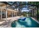 Screened-in pool and patio area featuring a basketball hoop and an outdoor lounge at 2903 Manor Ridge Pl, Valrico, FL 33596