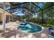 Private backyard pool with screened lanai, basketball hoop, and mature trees at 2903 Manor Ridge Pl, Valrico, FL 33596