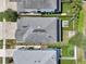 Aerial view of home showcasing dark roof, small patio and adjacent homes, with green yards at 307 S Arrawana Ave # 100, Tampa, FL 33609