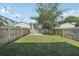 Large backyard with wood fence, green grass, and deck at 307 S Arrawana Ave # 100, Tampa, FL 33609