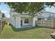 Backyard with covered patio and green grass at 307 S Arrawana Ave # 100, Tampa, FL 33609
