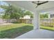 Covered patio with ceiling fan overlooking a spacious backyard with a wooden deck at 307 S Arrawana Ave # 100, Tampa, FL 33609