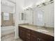 Bathroom showcasing a double vanity with granite counters, complemented by a tiled shower with a tub at 307 S Arrawana Ave # 100, Tampa, FL 33609