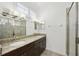 Bathroom featuring double sinks, granite countertops, and a glass-enclosed shower at 307 S Arrawana Ave # 100, Tampa, FL 33609