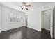 Spacious bedroom with dark wood floors, ceiling fan, and windows with shuttered window for ample light at 307 S Arrawana Ave # 100, Tampa, FL 33609