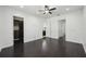 Large bedroom showcasing hardwood floors and multiple doors, including one to a walk-in closet at 307 S Arrawana Ave # 100, Tampa, FL 33609