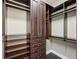Custom walk-in closet with dark wood shelving and drawers for organized storage at 307 S Arrawana Ave # 100, Tampa, FL 33609