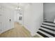Home foyer with hardwood floors and staircase at 307 S Arrawana Ave # 100, Tampa, FL 33609
