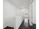Bright hallway with hardwood floors leading to a room with shuttered windows at 307 S Arrawana Ave # 100, Tampa, FL 33609