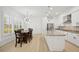 Open-concept kitchen with an island, stainless steel appliances, and a dining area with seating for six at 307 S Arrawana Ave # 100, Tampa, FL 33609