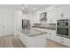 Well-equipped kitchen boasting stainless steel appliances, granite countertops, and an island for casual dining at 307 S Arrawana Ave # 100, Tampa, FL 33609