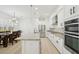 Open-concept kitchen features a long island, stainless appliances, granite countertops, and a view into the dining area at 307 S Arrawana Ave # 100, Tampa, FL 33609