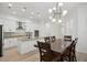 Modern kitchen showcasing white cabinets, stainless steel appliances, granite countertops, and a large kitchen island at 307 S Arrawana Ave # 100, Tampa, FL 33609
