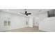 Bright, open-concept living room featuring white walls and hardwood floors at 307 S Arrawana Ave # 100, Tampa, FL 33609