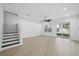 Open concept living room with stairs and sliding glass doors leading to yard at 307 S Arrawana Ave # 100, Tampa, FL 33609