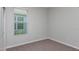 This cozy bedroom features plush carpeting and a window allowing for natural light at 3206 Lumber Falls Dr, Plant City, FL 33565