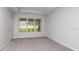 Bright bedroom with plush carpeting, neutral walls, a large window, and ample natural light at 3206 Lumber Falls Dr, Plant City, FL 33565