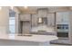 Modern kitchen featuring white quartz countertops, stainless steel appliances, and gray cabinetry at 3206 Lumber Falls Dr, Plant City, FL 33565