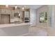Stylish kitchen with a large island, white countertops, gray cabinets, and stainless steel appliances at 3206 Lumber Falls Dr, Plant City, FL 33565