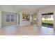 Open-concept living area with wood-look flooring, recessed lighting, and sliding glass doors at 3206 Lumber Falls Dr, Plant City, FL 33565